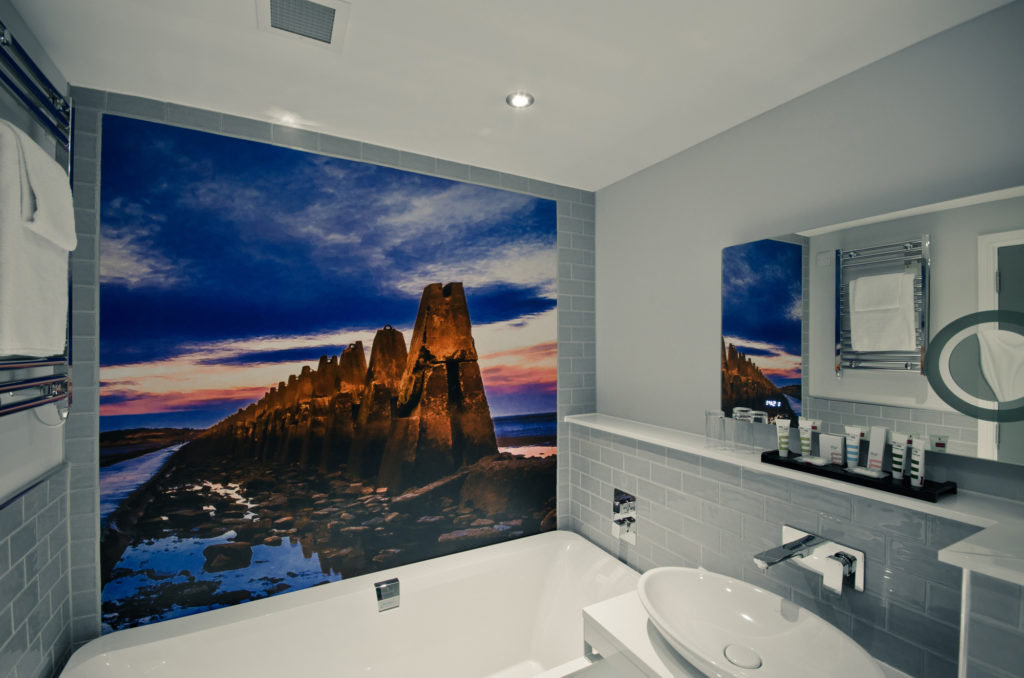 Superior room bathroom with photographic mural on wall behind bath