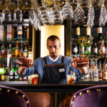 Bartender mixing cocktails at the Princes Street Bar inside Mercure Edinburgh City Princes Street Hotel.