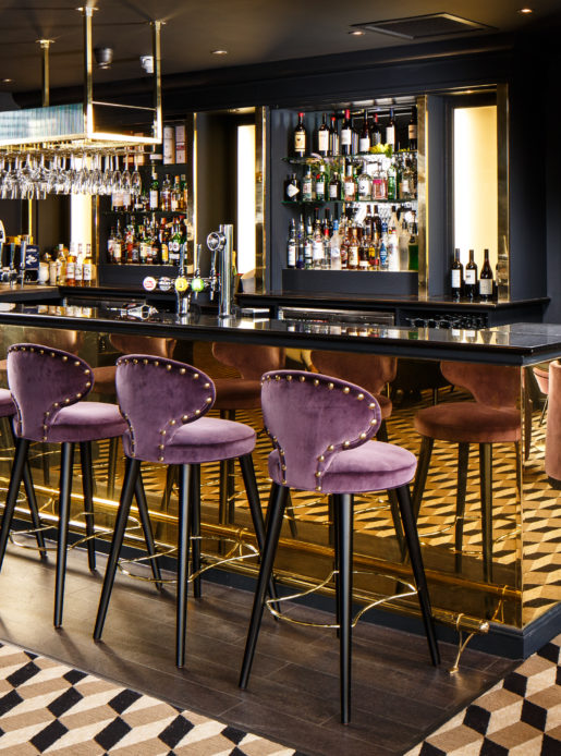 Bar area with purple bar stools at Mercure Edinburgh City Princes Street Hotel.